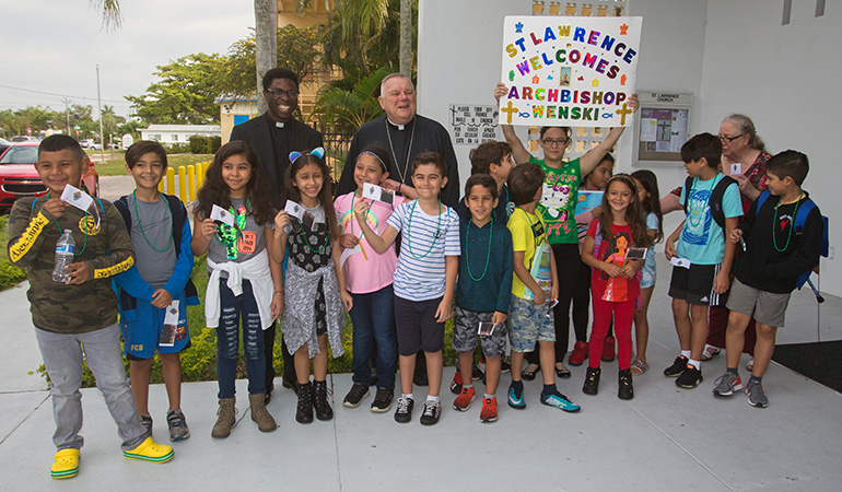 St. Lawrence School children welcome Archbishop Thomas Wenski for Mass and the dedication and blessing of new offices and rectory for the church.