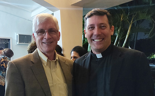 Ralph Martin, center, poses with his former student, Father Richard Vigoa, temporary administrator of St. Augustine Church and Catholic Student Center in Coral Gables, after giving a talk about the "new evangelization," March 21, 2019.