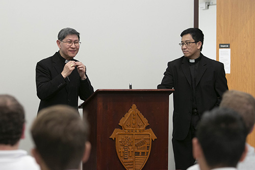 Father Ferdinand Santos, right, rector of St. John Vianney College Seminary in Miami, accompanies Cardinal Luis Antonio Tagle of Manila during a brief meeting with seminarians and staff the afternoon of March 22. The two have known each other for a number of years.