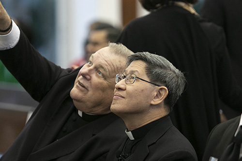 Archbishop Thomas Wenski points to a detail of the artwork at St. Raphael Chapel before Cardinal Luis Antonio Tagle of Manila delivered the annual Fides et Ratio lecture at St. John Vianney College Seminary, Miami.