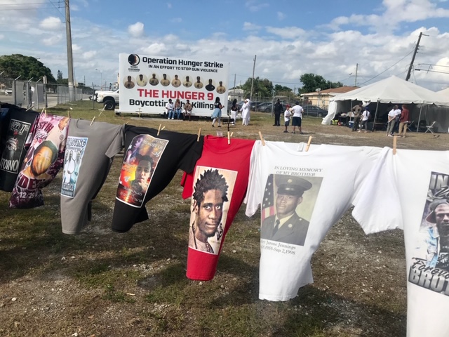 Images of victims of gun violence in urban communities hang on Tshirts at the Liberty City site of Operation Hunger Strike, staged by nine men who are part of a group called The Circle of Brotherhood. The Hunger 9 ended their strike March 29, saying the news and social media attention had made a difference. Archbishop Wenski visited the men March 24.