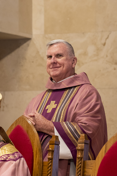 Father Gerald Morris, a retired archdiocesan priest and former pastor at St. Pius X, takes part in the Mass in commemoration of the 60th anniversary of the parish.