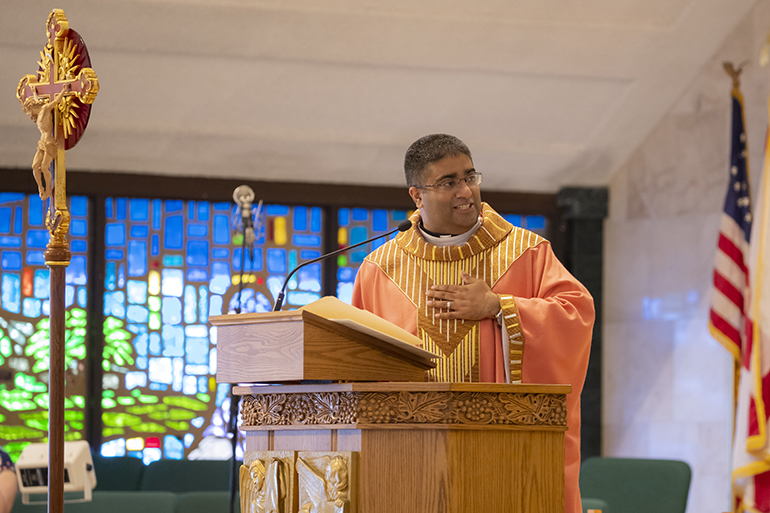 Father Biju Vells, pastor at St. Pius X Church in Fort Lauderdale, addresses his congregation during the Mass celebrating the parish's 60th anniversary.
