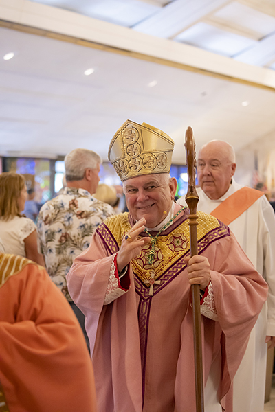 Archbishop Thomas Wenski greets parishioners at the end of the Mass celebrating the 60th anniversary of St. Pius X Church in Fort Lauderdale.