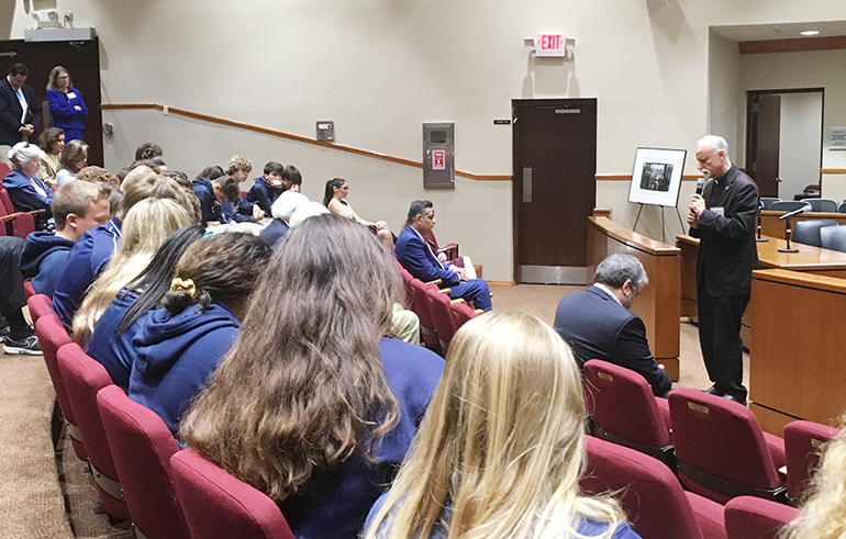 Father Alfred Cioffi leads participants in prayer at the conclusion of St. Thomas University's Second International Conference on Climate. His prayer: "We can, we should" do something about climate change, global warming and other environmental issues.