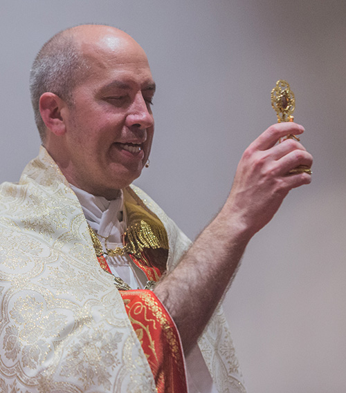 Father Joseph Rogers holds up a relic of St. Francisco during the commemoration of the centenary of the deaths of St. Francisco and St. Jacinta, the shepherd children who received apparitions from the Virgin Mary in 1917.