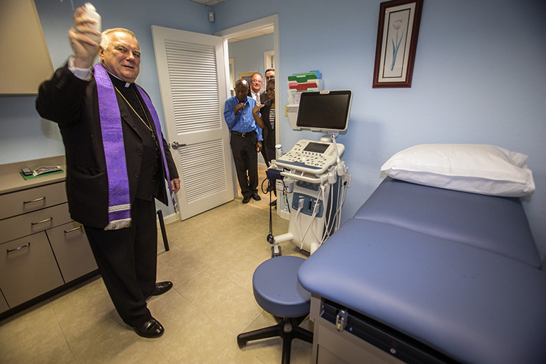 Archbishop Thomas Wenski blesses the new ultra sound machine at the Central Broward Pregnancy Help Center April 12, 2019.