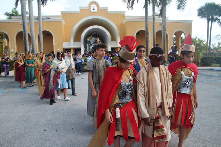 Mother of Our Redeemer eighth-graders accompany Jesus, played by Simeon Fleuridor, during the re-enactment of the Stations of the Cross.