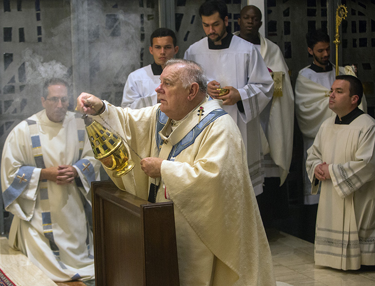 Archbishop Thomas Wenski censes the tabernacle where the Blessed Sacrament is exposed at the conclusion of Holy Thursday Mass of the Last Supper at St. Mary Cathedral.