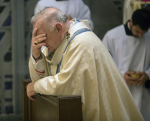 Archbishop Thomas Wenski prays before the Blessed Sacrament at the conclusion of Holy Thursday Mass at St. Mary Cathedral.