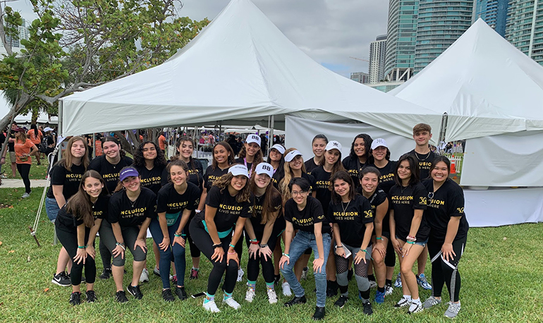 Members of Chaminade-Madonna's Best Buddies Club pose after taking part in the Friendship Walk in downtown Miami March 16. The school's team raised $ 10,319, a more than $ 7,000 increase from last year.