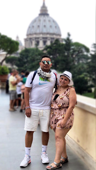 Angela Suazo and her husband, Angel, pose for a photo in Vatican City, which was on her bucket list of places to see. In the background is the dome of St. Peter's Basilica.