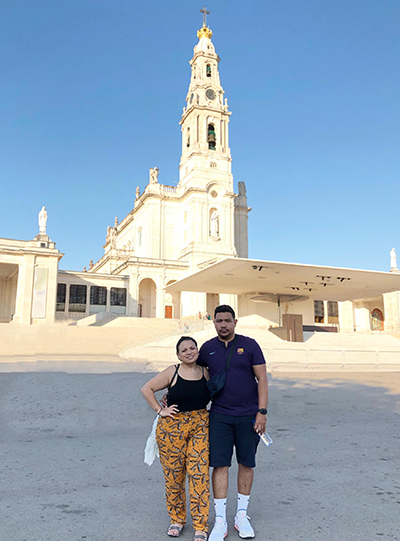 Angela Suazo and her husband, Angel, pose outside the Sanctuary of Our Lady of Fatima in Portugal.