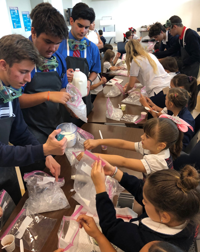 What better way to end a day of experimenting than experimenting with a little bit of homemade ice cream? Columbus High students team up with St. Brendan School first graders to make a tasty treat.