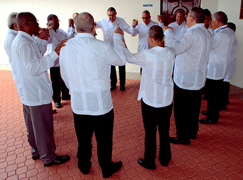 Ushers pray before Mass at St. Edward Church.