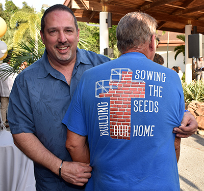 William Shashaty shows off a fundraising campaign T-shirt at St. Edward Church. The church held a mortgage-burning celebration May 18.