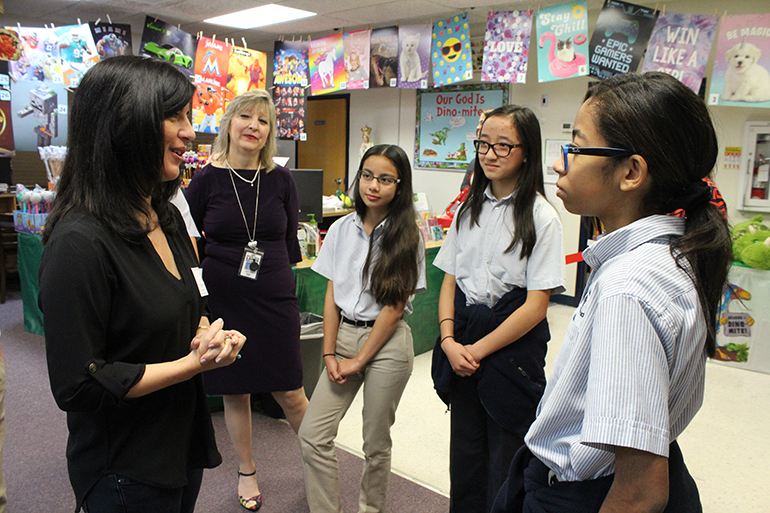 Book talk: Author Christina Diaz Gonzalez, far left, asks St. Mark School students what their favorite book genres are and discusses some of her own experiences in reading and writing. Listening, from left, are Sandy Garcia, St. Mark media specialist, and students Isabella Rubio, Alexandra Scott, and Isabel Strong.