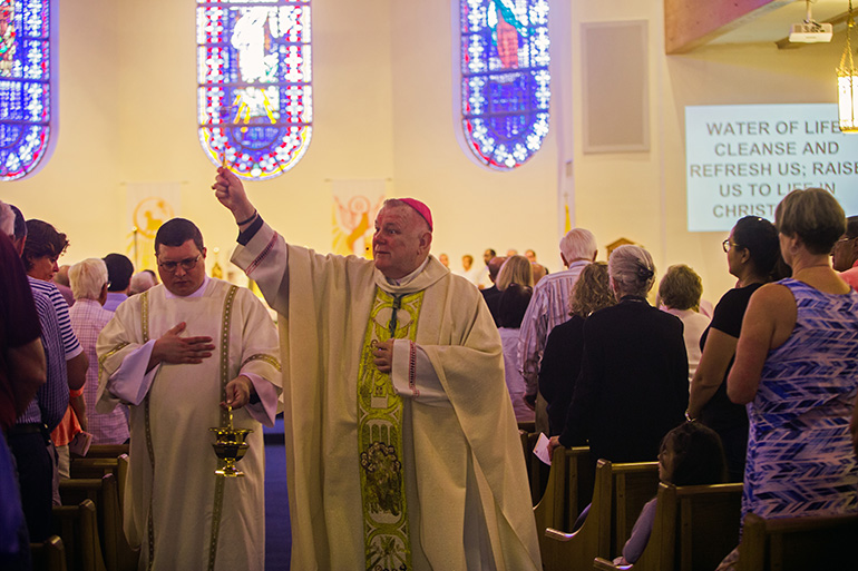 Archbishop Thomas Wenski blesses the congregation during the 60th anniversary Mass for Assumption Church in Lauderdale-By-The-Sea. Parishioners celebrated the 60th anniversary of their parish, and the 25th anniversary of the dedication of their church, April 27, 2019.
