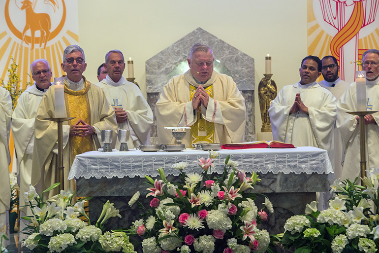 Archbishop Thomas Wenski and Father Michael Greer, left front, pastor of Assumption Church in Lauderdale-By-The-Sea, celebrate the 60th anniversary Mass for the parish. Parishioners celebrated the 60th anniversary of their parish, and the 25th anniversary of the dedication of their church, April 27, 2019.