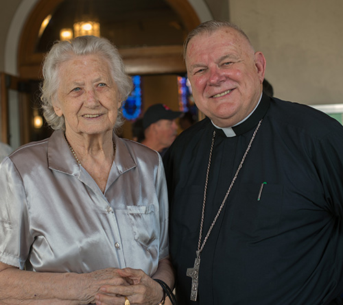 Antonia Stefanic, 92, a parishioner since the 1950s, poses for a photo with Archbishop Thomas Wenski after the 60th anniversary Mass for Assumption Church in Lauderdale-By-The-Sea.