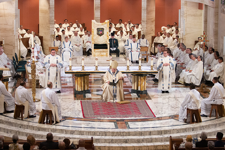 As the deacons sit around the sanctuary, Archbishop Thomas Wenski preaches his homily before a standing-room only St. Mary Cathedral, where nearly 1,000 people witnessed the joyous, tradition-filled Mass of ordination for five new priests for the Archdiocese of Miami, May 11, 2019.