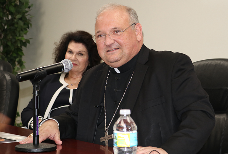 Miami Auxiliary Bishop Peter Baldacchino answers questions from the media May 16, a day after the Vatican announced he had been appointed the third bishop of the Diocese of Las Cruces, New Mexico. Behind him is Mary Ross Agosta, archdiocesan director of communications.