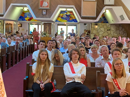 Members of the 2019 confirmation class at Our Lady of Czestochowa Polish Mission in Pompano Beach listen to his homily at the confirmation Mass May 19.