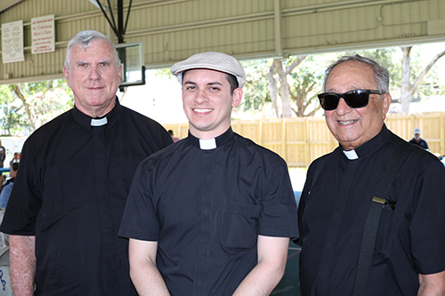 From left: St. Coleman's Father Gerald Morris, parochial vicar, Father Michael Garcia, administrator, and Father Eugene Marcone, who helps out, gather to talk during the parish's anniversary celebration May 19, which also included recognitions and celebrations of Father Thomas Foudy's life. Father Foudy, a former pastor, died the morning of the anniversary celebration.