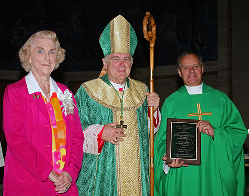 Marjorie Wessel, president of the Catholic Educators Guild, poses with Archbishop Thomas Wenski and St. Thomas University President Msgr. Franklyn Casale after he received the 2013 Lumen Christi award from the guild.