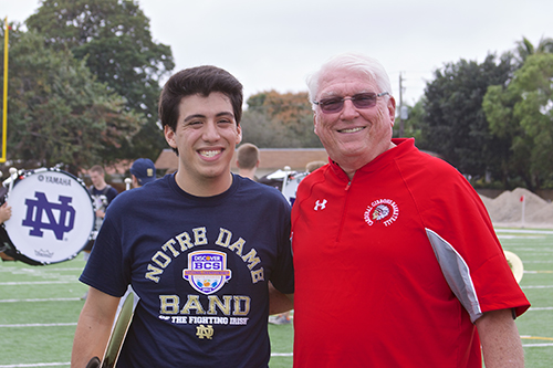 In this January 2013 photo, Paul D. Ott, Cardinal Gibbons' principal and a Notre Dame alumnus, poses with Alex Romeu, a Gibbons alumnus and member of the Notre Dame marching band. The band practiced on the Gibbons football field before their performance at the 2013 national championship bowl game against Alabama's Crimson Tide.