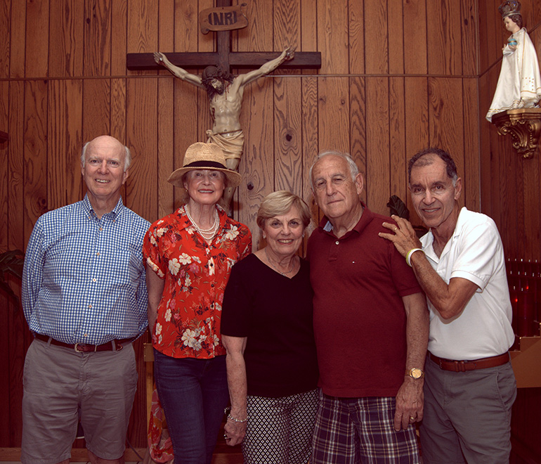 Alumni of Sts. Peter and Paul School revisit the parent church in Miami during their 70th anniversary reunion. They're standing in the chapel, where the church's original crucifix stands. From left are Joe Annis, Barbara Annis, Nancy Kelly Dodd, Dr. Serge Martinez and Paul George.