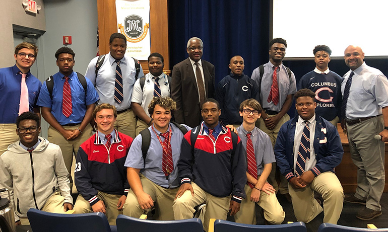 Albert Dotson Jr., real estate attorney and vice chair of 100 Black Men of America, Inc., poses with some of Christopher Columbus High School's students during a visit and talk at the campus for Black History Month. At far right is social studies lead teacher Alex Trujillo, who felt inspired to start the lecture series.