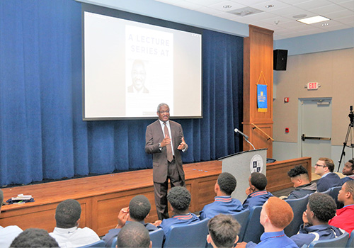 Albert Dotson Jr., real estate attorney and vice chair of 100 Black Men of America, Inc., speaks to Christopher Columbus High School students as part of a new lecture series to mark Black History Month.