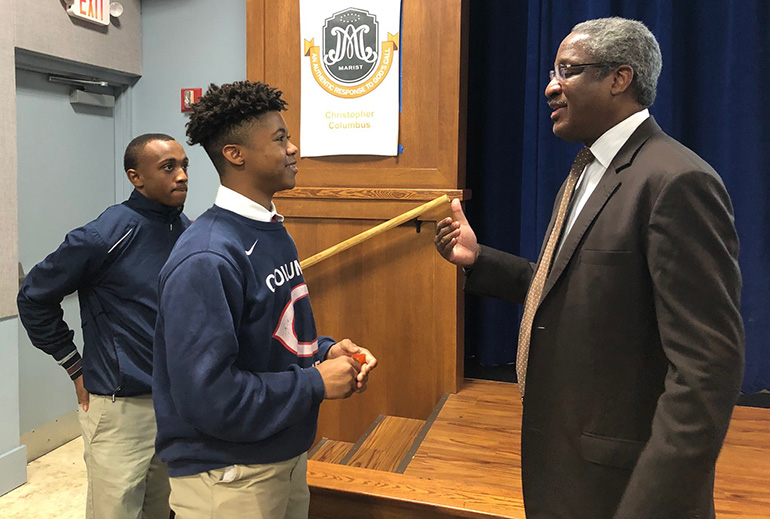 Albert Dotson Jr., real estate attorney and vice chair of 100 Black Men of America, Inc., talks with Christopher Columbus High School's Garrelleon Riley as fellow student Joseph Luisias looks on. Dotson was one of a series of local professionals  who shared their inspirational and motivational stories at a new lecture series marking Black History Month.