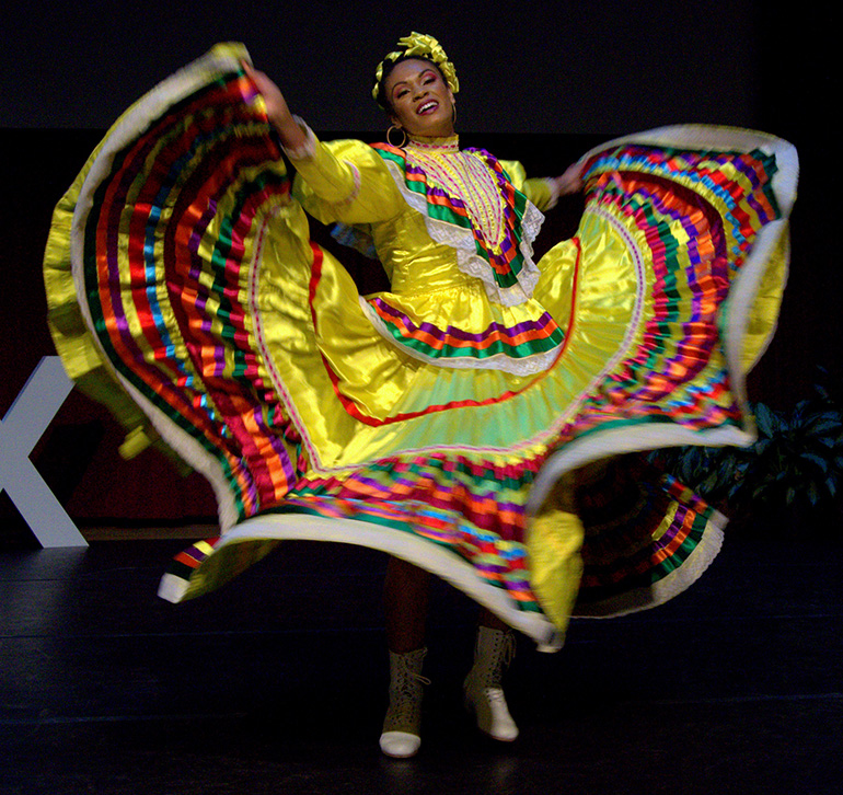 May Basse, a teacher at St. Thomas Aquinas High School in Fort Lauderdale, does a Mexican-style dance during TEDx, a recent forum of speeches and performances at St. Thomas Aquinas High School in Fort Lauderdale.