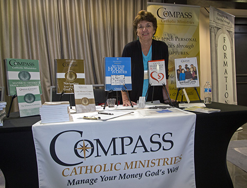 Evelyn Bean, co-founder with her husband of Compass Catholic Ministries, poses at her display at the second Florida Statewide Stewardship Day, held May 4 in downtown Miami.