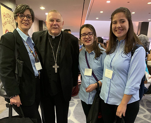 From left, Sara Salomon and her daughters, Mara and Lara Briceño, pose with Archbishop Thomas Wenski after he celebrated the opening Mass at the Second Statewide Stewardship Day, held at the Hilton Hotel in downtown Miami May 4. The family is involved with the Por Amor a Cristo (For the love of Christ) stewardship group at at their parish, St. Dominic Church, Miami.