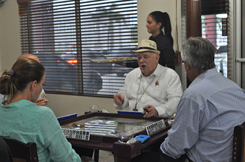 Archbishop Thomas Wenski reacts while playing dominoes during the annual Havana Nights fundraiser for Catholic Charities' Unaccompanied Minors Program.