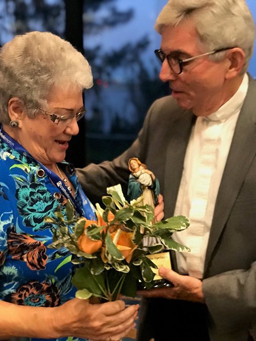 The Miami Archdiocesan Council of Catholic Women's Our Lady of Good Counsel award recipient, Claudette Spelman, of St. Andrew Council, accepts a statue of the group's namesake presented to her by Father Michael J. Greer, spiritual advisor, during the MACCW's 61st annual convention at the Miami Airport Hilton May 17.