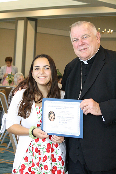 Archbishop Thomas Wenski poses with Blessed Trinity eighth-grade student Gena Escanaverino, one of three scholarship recipients awarded $ 5,000 to attend a Catholic high school. The award was presented at the Miami Archdiocesan Council of Catholic Women's Scholarship Award Luncheon, held during the group's 61st annual convention, May 18 at the Miami Airport Hilton.