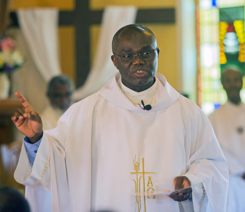 Father Fidelis Nwankwo, St. Philip Neri administrator, preaches the homily at the parish's 65th anniversary Mass.