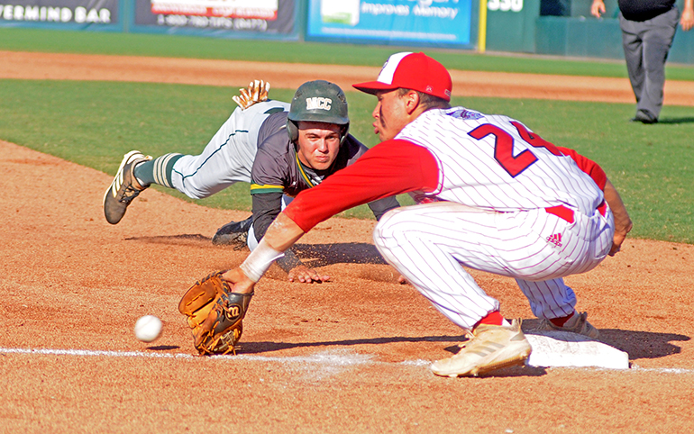 Cardinal Gibbons third baseman Felix Torres reaches for a throw from left fielder Tim Manning (unpictured) to tag out Melbourne Central Catholic runner Cam Maruzzella during the seventh inning of their Florida Class 5A baseball state championship game May 30.