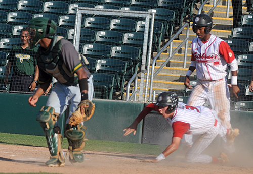 Cardinal Gibbons runner Michael Higgins reaches back to touch home with the tying run in the bottom of the seventh inning of the Chiefs' Florida Class 5A baseball state championship game against Melbourne Central Catholic May 30. Isaiah Farris, right, also scored on Brice Montiel's two-run single but Melbourne Central Catholic won the game 6-3 in eight innings.