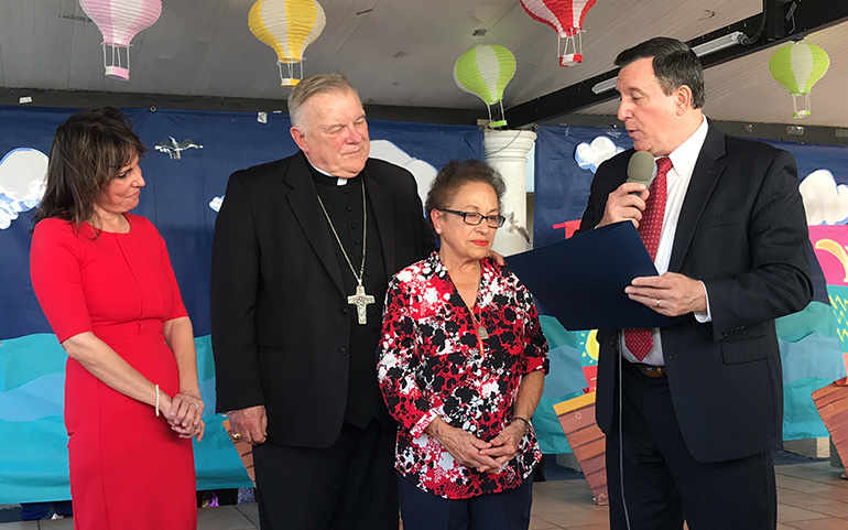 City of Miami Commissioner Joe Carollo presents a Certificate of Merit to Clara Gesni, a Centro Mater teacher who is about to retire after over 30 years of service to the children and families served by the organization. Looking on, from left, are Madelyn R. Llanes and Archbishop Thomas Wenski.