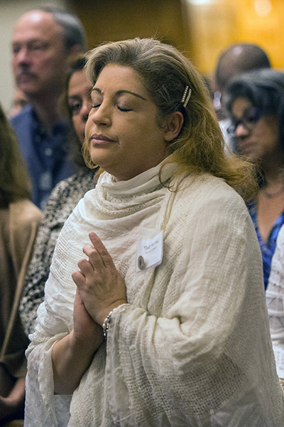 Zully Mar Vidal, who was re-commissioned for another five years of service in prison ministry, prays during the Mass.
