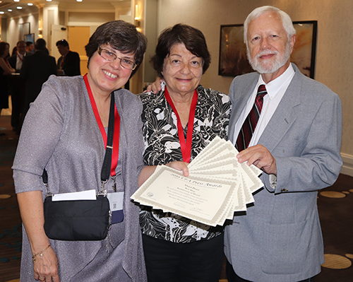 Holding up their award certificates after the awards banquet in St. Petersburg, from left, are Florida Catholic editor Ana Rodriguez-Soto and freelance reporters/photographers Marlene Quaroni and Jim Davis. (JEAN GONZALEZ | FC)