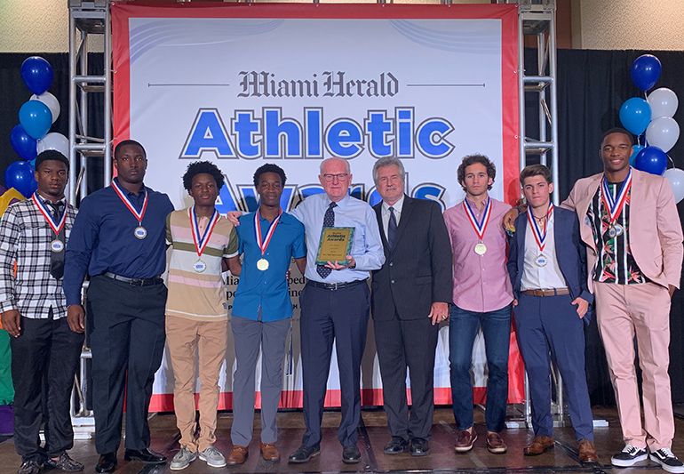 Columbus athletes and coaches pose at the Miami Herald All Dade Breakfast, where all First Team All-Dade athletes, scholar athletes and coaches were honored. Athletic Director Chris McKeon and the whole program won the 9A-7A boys' major sports award after defending the school's track and field state title, finishing as state runner-up in football and winning the Greater Miami Athletic Conferences in both baseball and soccer. In all, Columbus had 24 student-athletes recognized including Henry Parrish, Jr. (Football Offensive Player of the Year), Nick Regalado (Pitcher of the Year), Nicholas Suarez (Scholar Athlete) and Gary Cooper (Athlete of the Year Finalist).