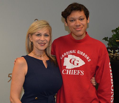 Lori Kubach, assistant principal of academics at Cardinal Gibbons High, poses with junior William Gonzalez, who got a perfect score of 36 on his first attempt at the ACT college admissions test.