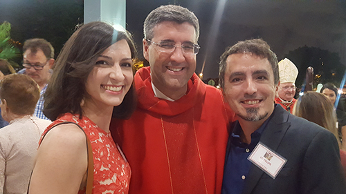 Cristina Cabrera Jarro (left) and her brother Felipe Cabrera Jarro (right) pose with Father Manny Alvarez after their Confirmation ceremony at Immaculate Conception Church in Hialeah.