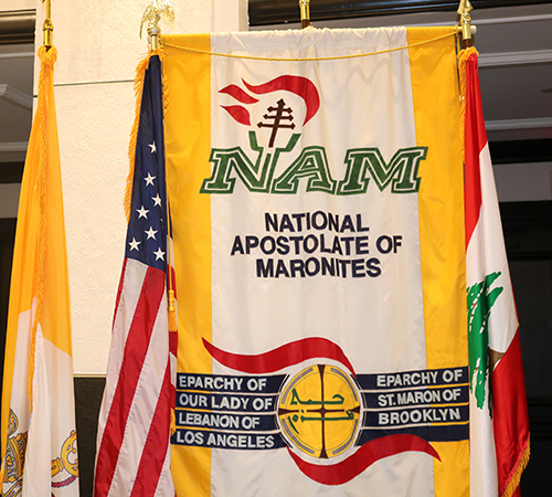 A National Apostolate of Maronites banner is part of displays at the Maronite Convention held in Miami June 26-30 at the Loews Hotel. The members of the apostolate assist the bishops, help bring Maronite laity in the United States together, and help strengthen the bonds between clergy and lay. The group sponsors the national convention each year. This year marks the convention's 56th year.